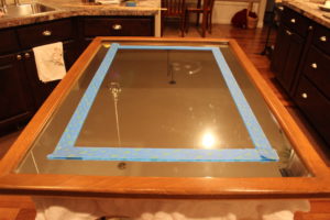 A picture of the mirror with the frame taped on.