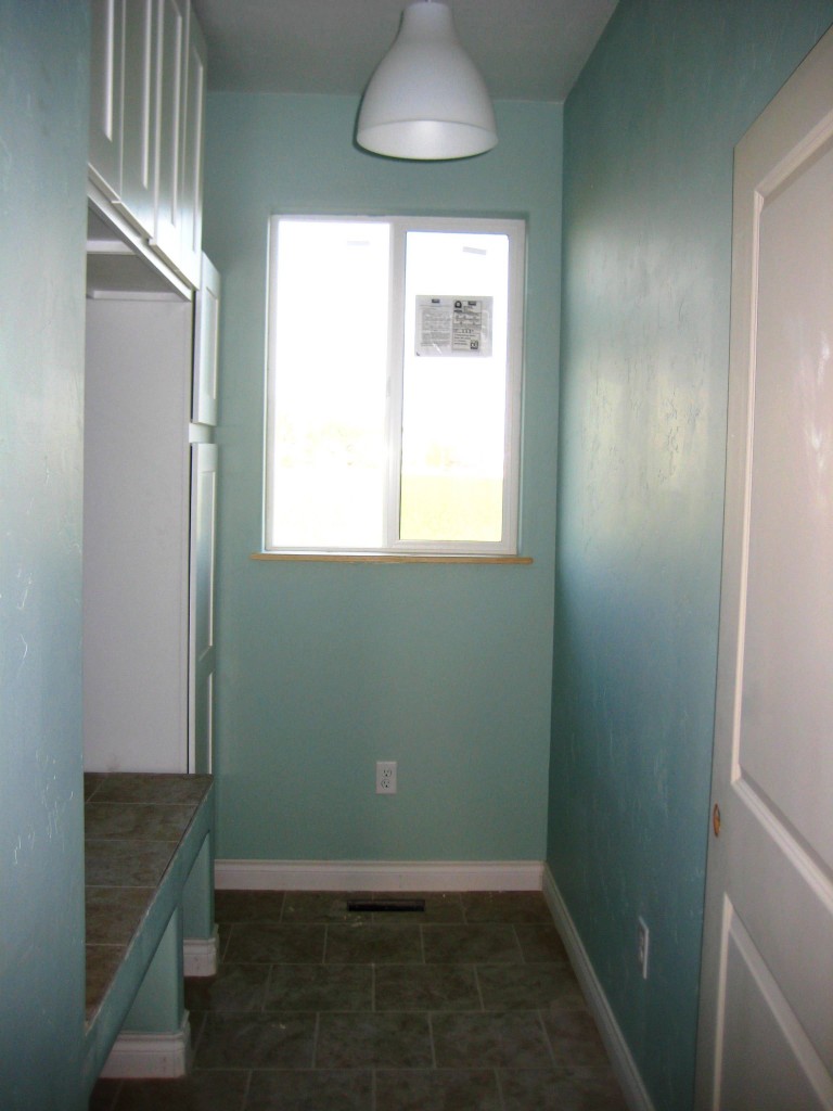laundry room before by The Wood Grain Cottage
