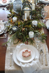 A pictures showing a fall table setting with candles.