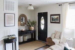A picture of an entry with a black front door.