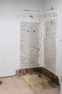 A picture of a gutted master bathroom.