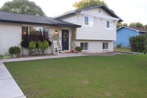 A picture of the front of the house with new grass.