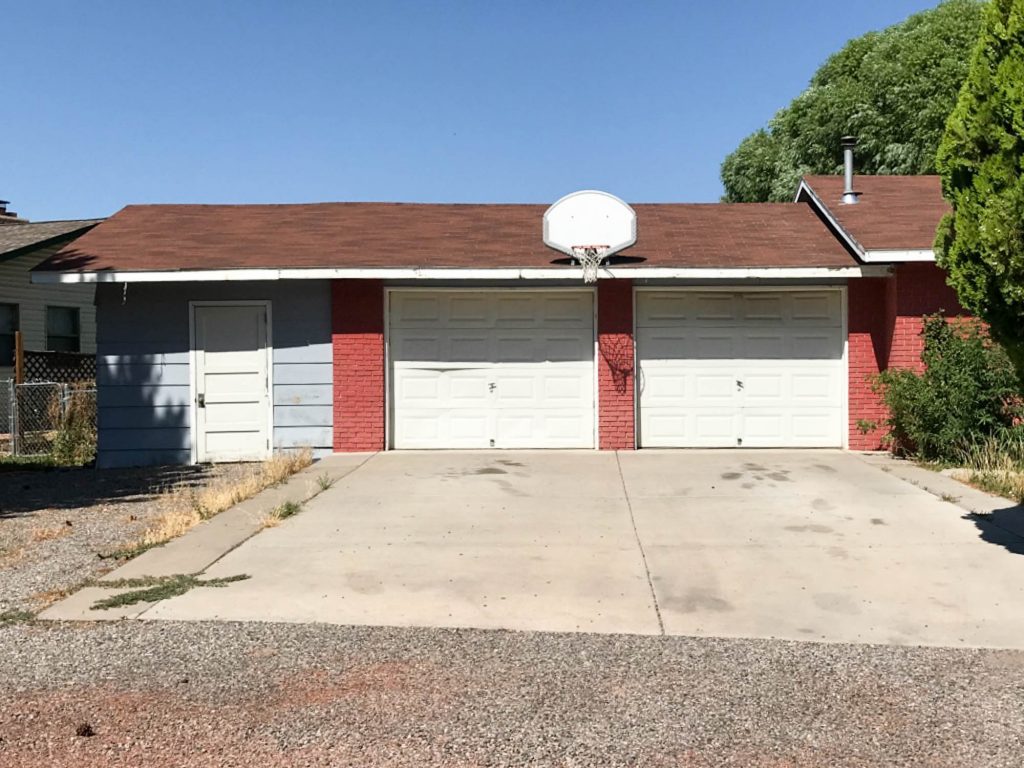 A picture of the house and garage doors when we first bought the house.