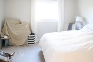 A picture of a bedroom with blankets covering all the furniture.