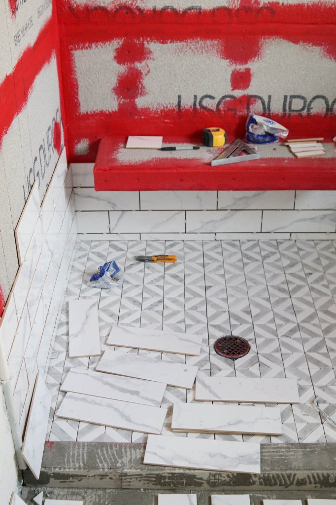 A picture of the shower tile being installed. 