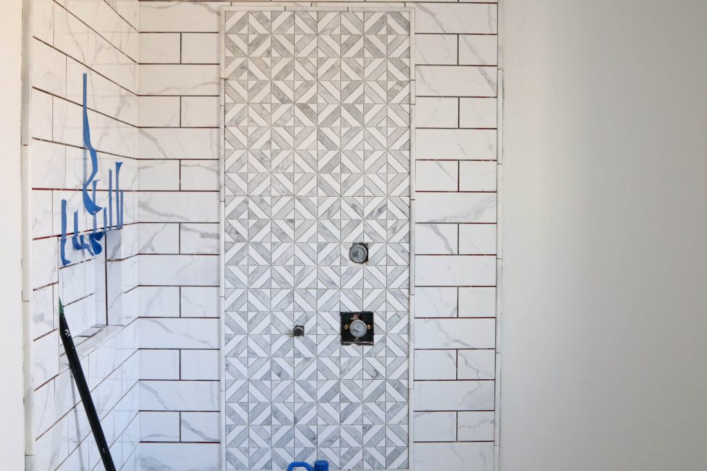 A picture of the shower tiled. 