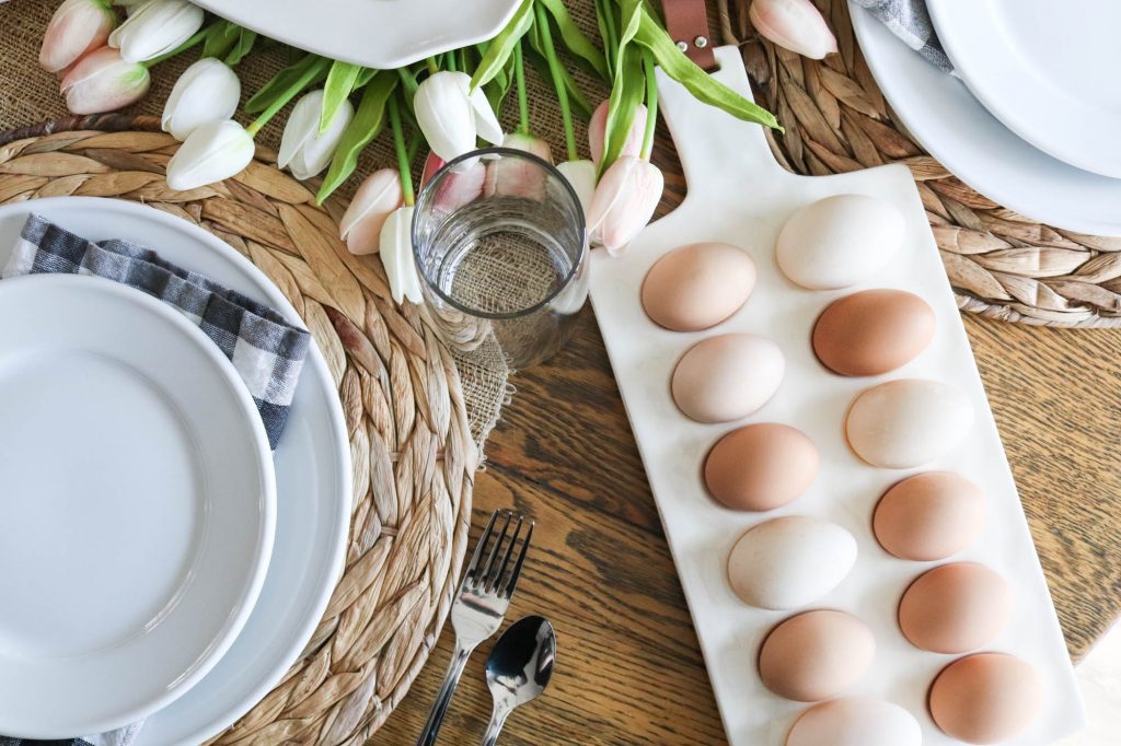 A picture of a table set for Easter with an egg serving platter. 