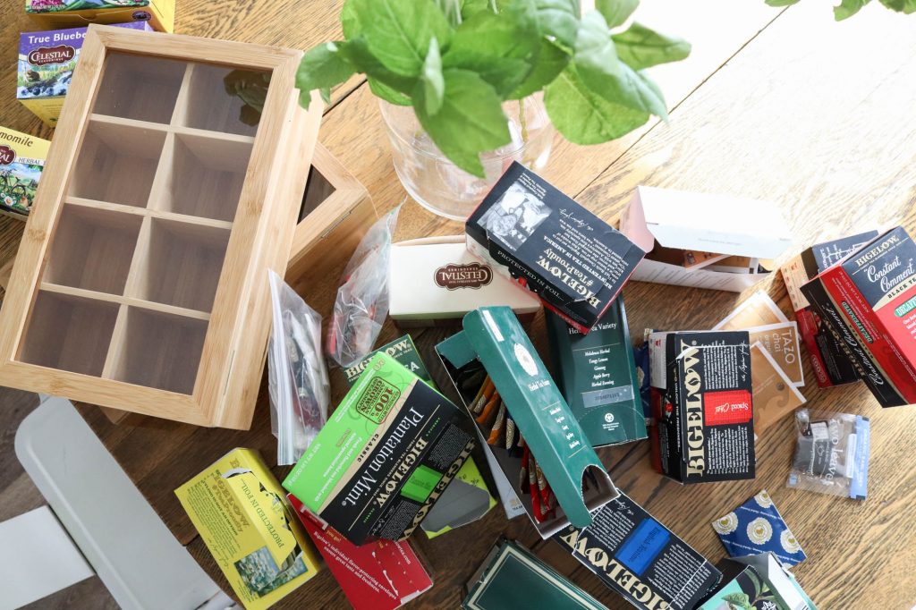 A picture of hot tea boxes and wooden organizing boxes.