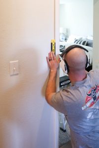 A picture of Todd installing door trim.