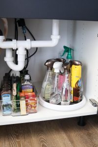 A picture showing the final outcome of organizing under the kitchen sink.
