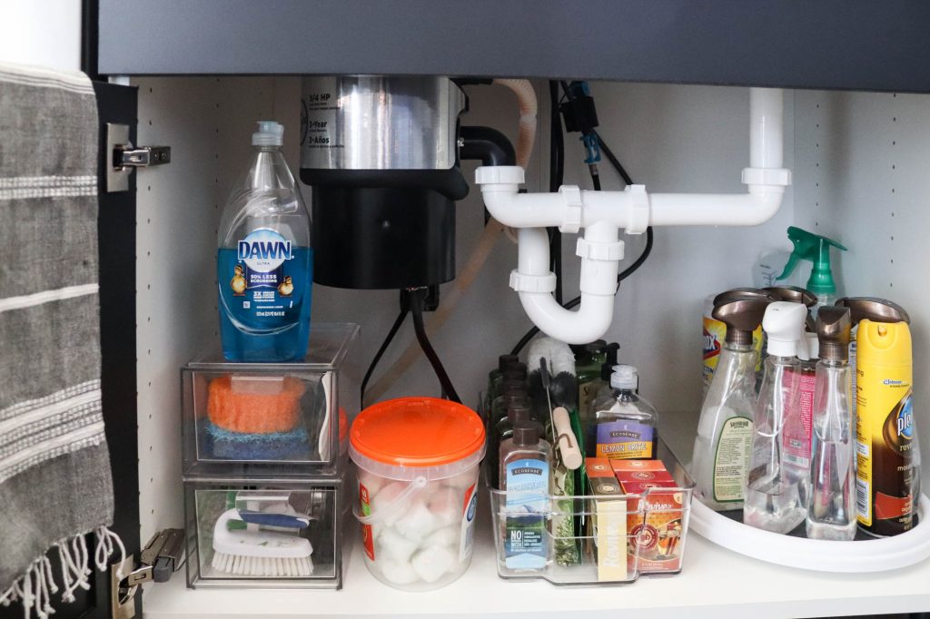 A picture showing the final outcome of organizing under the kitchen sink.