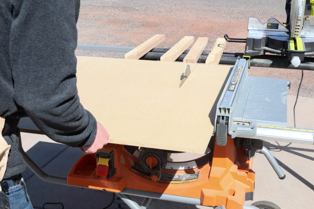 A picture of Todd using a table saw to cut the material to size...