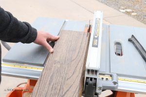 A picture of a stair tread being cut on the table saw.