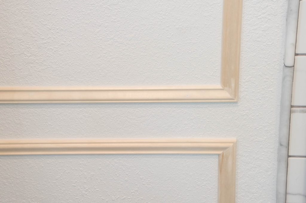 A picture of the wall moulding caulked and the nail holes filled. 