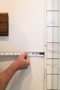 A picture of Todd measuring the wall.