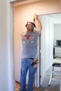 A picture of Todd installing door trim.