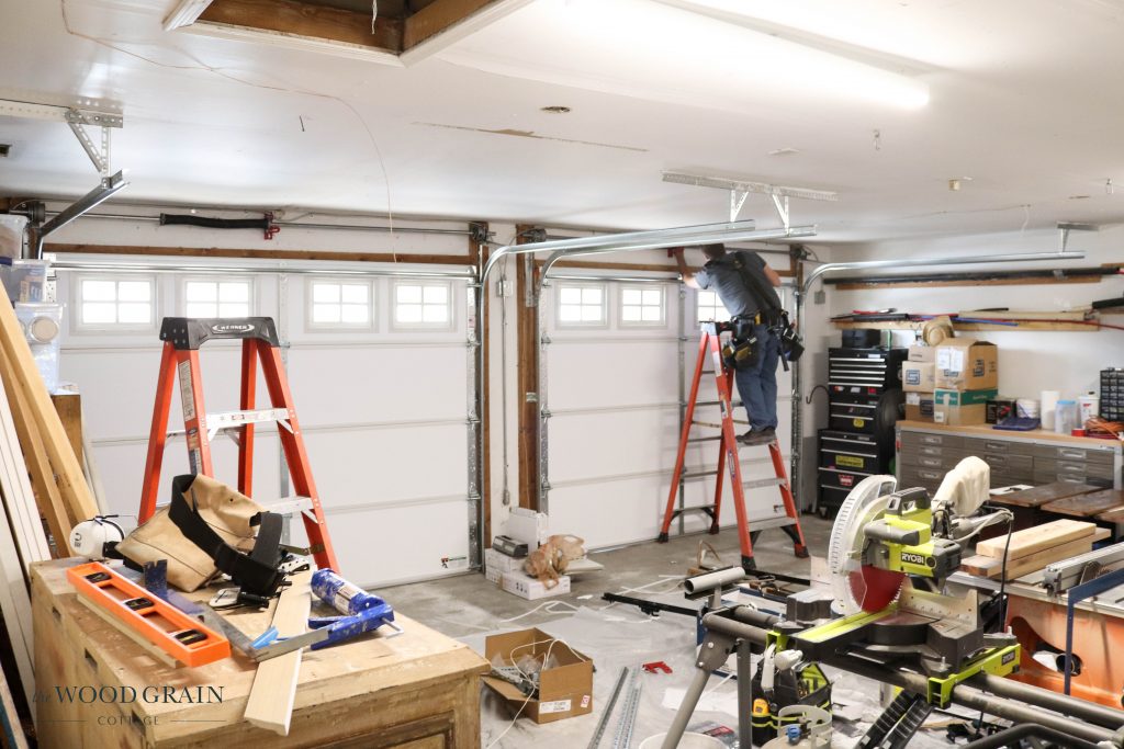 A picture of the inside of the garage with new garage doors. 