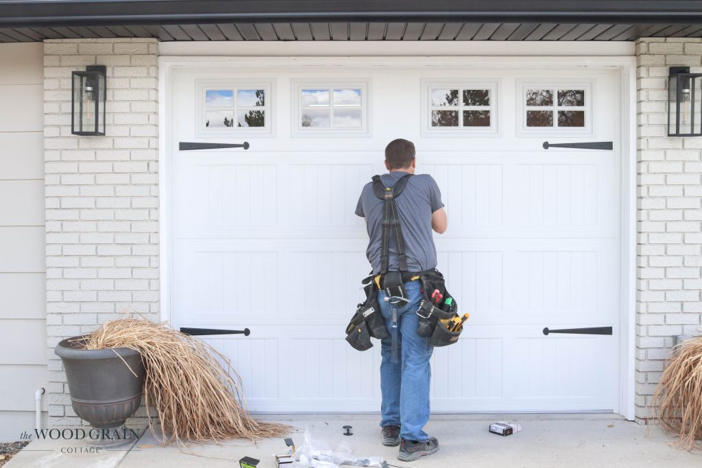 A picture of hardware being installed on the new garage doors. 