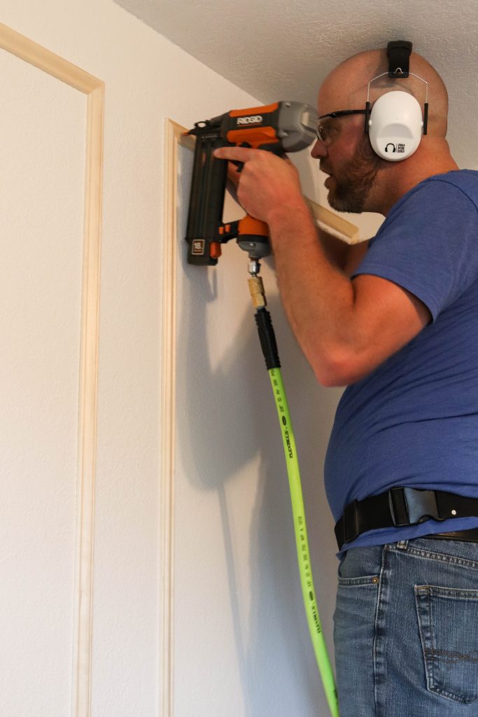 A picture of Todd installing the wall moulding. 