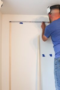 A picture of Todd installing the wall moulding.