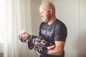 A picture of Todd holding the baby.