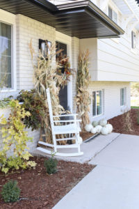 A picture of our fall front porch with cornstalks.