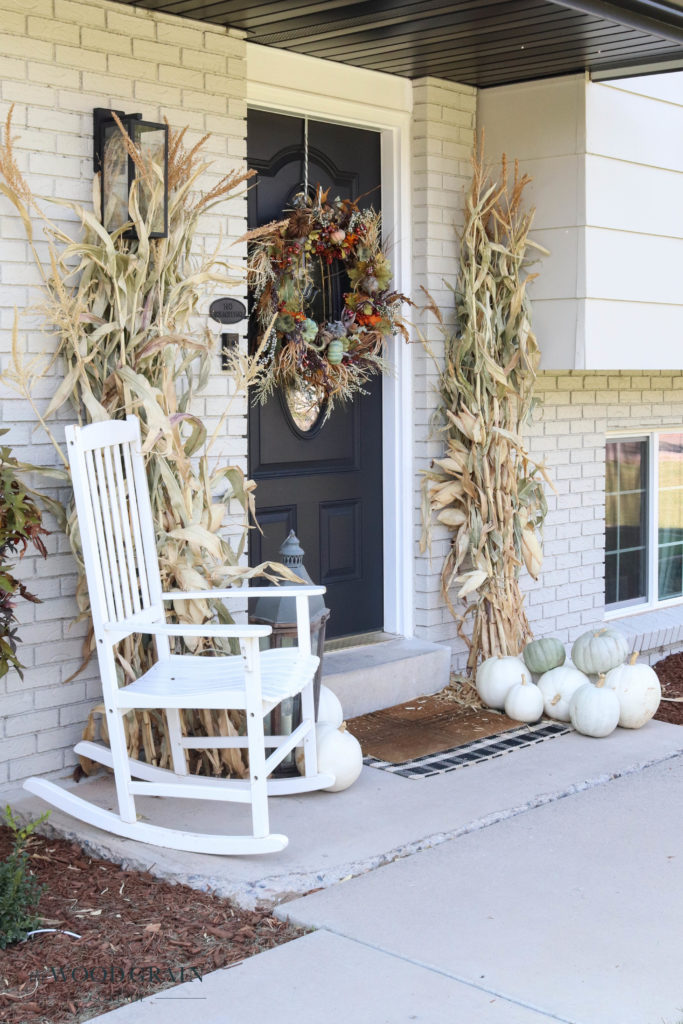 A picture of our fall front porch with cornstalks and white pumpkins. 