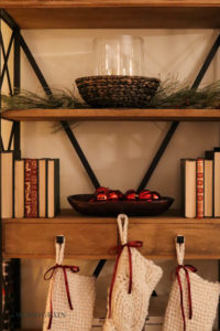 A picture of our living room open shelves decorated for Christmas.