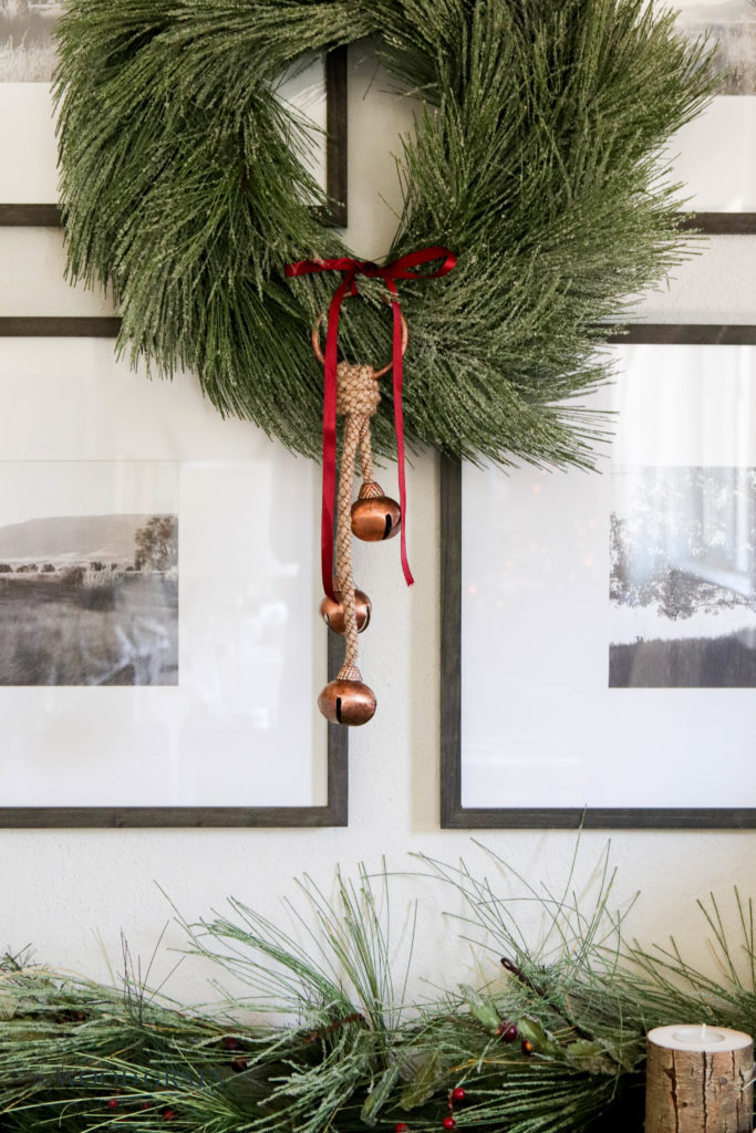 A picture of a big wreath with jingle bells.