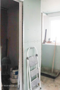A picture of the bathroom with drywall.