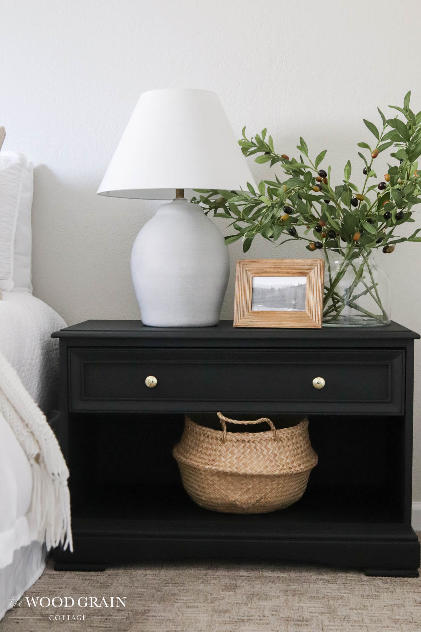 A picture of the finished nightstand painted black.