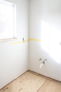 A picture of the bathroom sink area gutted.