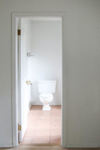 A picture of the bathroom doorway and the toilet.