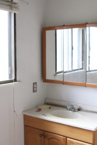 A picture of the bathroom vanity before.