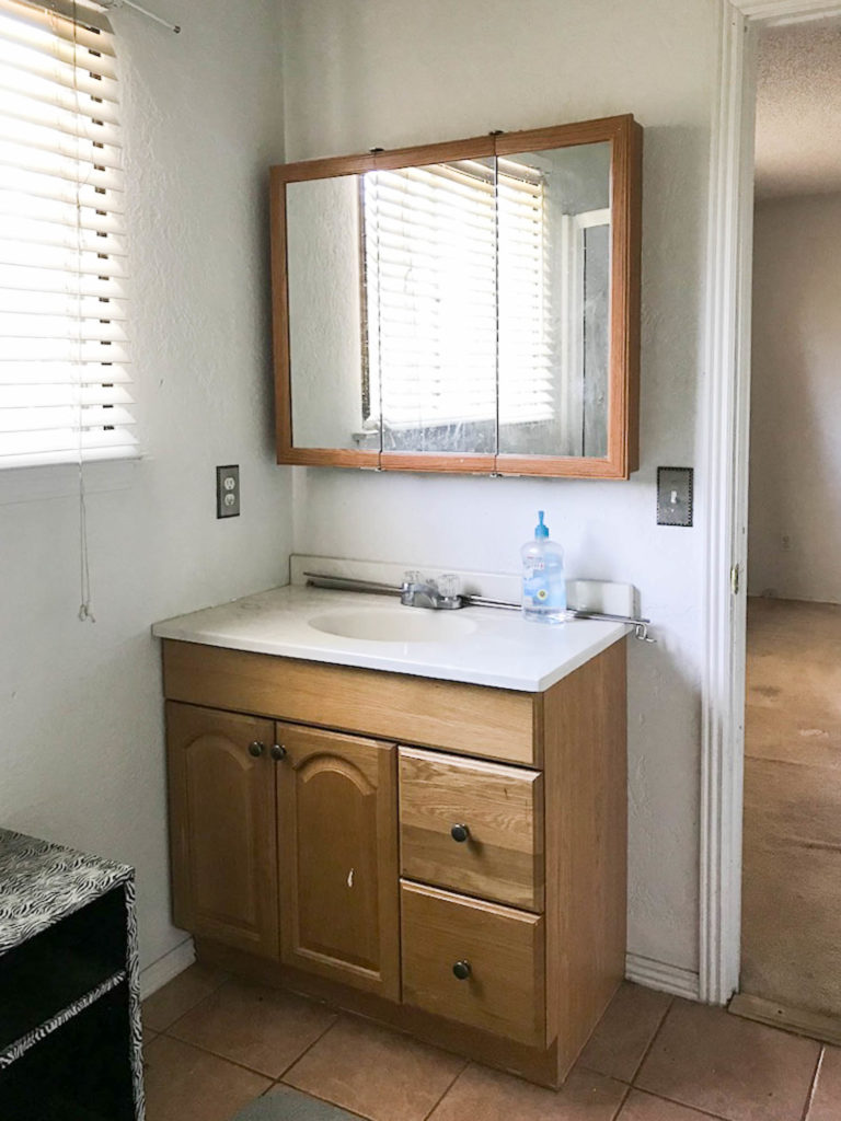 A picture of the bathroom vanity before. 