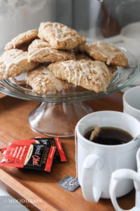 A picture of the gluten free spiced chai scones and a tray of hot tea mugs.