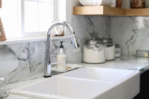 A picture of our kitchen sink and faucet.