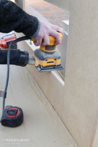 A picture of Todd sanding down the mdf.
